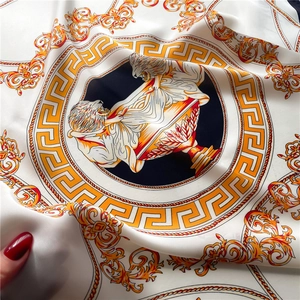 Detail of silk scarf with baroque gold lion patterns and greek key border satin finish