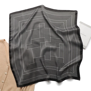 Detail of silk satin square scarf with modern black and white geometric striped patterns