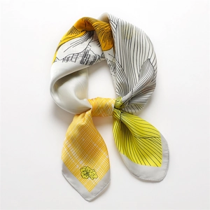 Silky satin scarf with yellow floral and grey sketch patterns, tied in an elegant ring shape