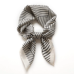 Elegant black and white striped silk-like satin square scarf tied for professional styling