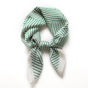 Striped green and white silk square scarf with geometric pattern tied in a stylish knot