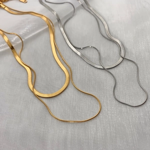 Double-layered gold and silver herringbone chains with minimalist metallic finish