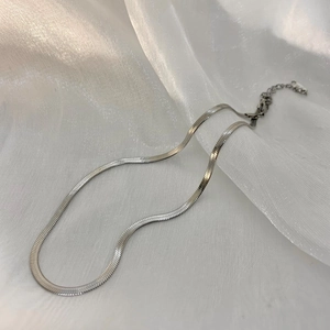 Detailed view of silver flat snake bone chain necklace with adjustable lobster clasp