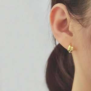 Elegant gold-plated teardrop double-hoop earrings shown on model for a minimalist aesthetic