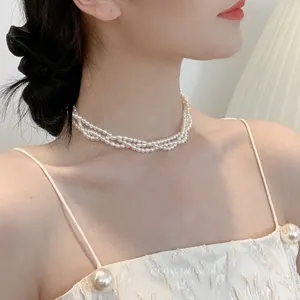 Close-up of triple-layered freshwater pearl choker on a model with vintage style