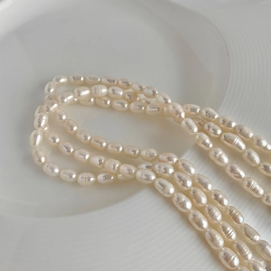 Close-up of multi-layer baroque freshwater pearl necklace on minimalist white tray