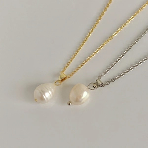 Detailed view of baroque freshwater pearl pendants in gold and silver finish options