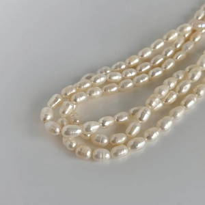 Macro shot of multi-layer rice-shaped freshwater pearl necklace with warm creamy glow