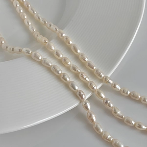 Macro detail of layered baroque freshwater pearls on white ceramic plate with fine luster