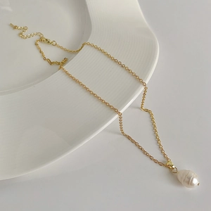 Detail of baroque freshwater pearl pendant on golden chain with adjustable extension