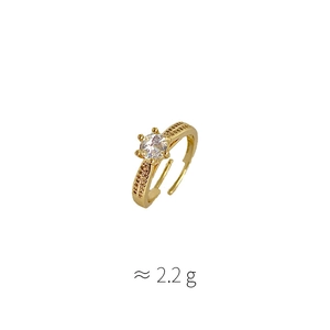 Detail of gold open ring with six-prong set zircon and pavé side stones weighing 2.2g