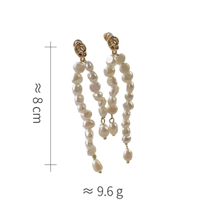 Detailed view of long baroque pearl tassel earrings with gold finish, 8cm length and 9.6g weight