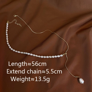 Detailed view of freshwater pearl necklace with gold chain and teardrop pendant