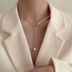 Baroque freshwater pearl necklace with asymmetric gold chain and teardrop pendant