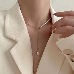 Elegant gold Y-shaped necklace with freshwater pearls and baroque pendant on model
