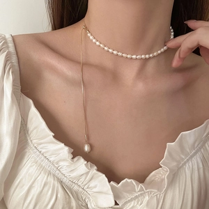 Close-up of Baroque freshwater pearl necklace with teardrop pendant on a model neck