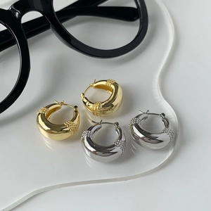 Minimalist hollow water drop hoop earrings in gold and silver finish with textured accents