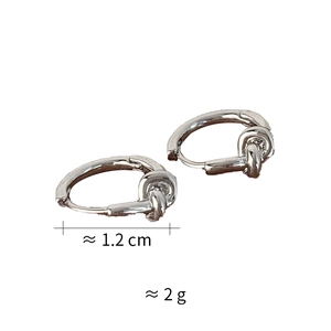 Macro detail of silver knot hoop earrings showing 1.2cm diameter and 2g weight specs
