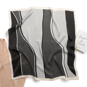 Detailed texture of black and white geometric silk scarf with elegant stripe patterns
