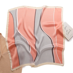 Detail of pink and brown geometric silk scarf with delicate line patterns and stitching
