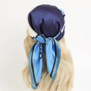 Blue geometric color-block satin silk scarf tied as a stylish headband for women