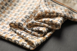 Detailed close-up of horse head print silk scarf showing soft texture and premium luster