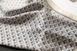 Detailed close-up of silk scarf fabric showing a natural drape and soft satin luster