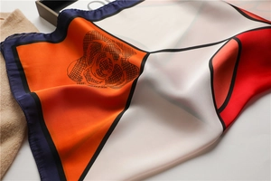 Detail of silk scarf with geometric color block and black line rose pattern