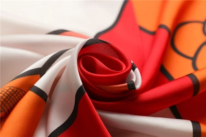 Detailed close-up showing the smooth silk texture and red geometric pattern of the scarf