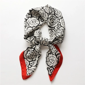 Elegant vintage camellia print silk scarf with striking red border in a bow shape