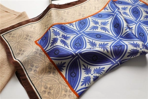 Détail d'un foulard en soie aux motifs floraux vintage et bordures contrastées