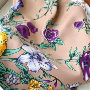 Close-up of floral twill silk scarf showing soft texture and elegant pattern details