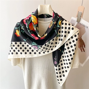 Floral and polka dot 90x90cm silk scarf styled on a white sweater with a magazine