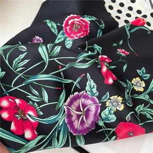 Detail of floral silk scarf with polka dot patterns and smooth satin texture shine