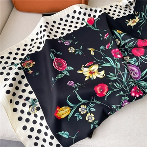 Detailed view of the floral silk scarf featuring vibrant tulips and classic polka dot patterns