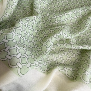 Macro shot of light green and beige geometric ring pattern fabric with soft texture