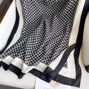 Close-up of interlocking chain pattern on lightweight black and white scarf