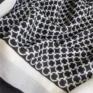 Macro detail of black and white geometric chain print on textured linen cotton shawl