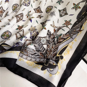 Detail of luxury cotton linen scarf featuring vintage feather and floral motifs