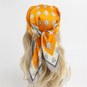Elegant bright orange silk square scarf with geometric H pattern as a headpiece