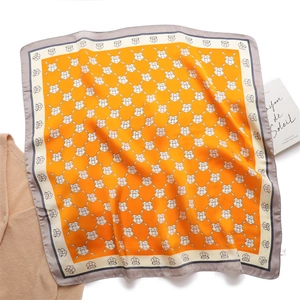 Elegant orange silk square scarf with white shield pattern and grey border display