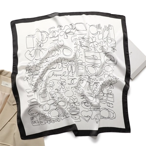 Detail of luxury silk scarf with black and white sketches of perfume and heels