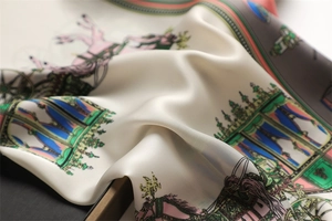 Detailed close-up of a luxury silk scarf with elegant horse carriage prints and patterns