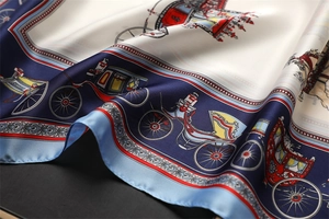Close-up of elegant carriage print silk scarf with classic gold and blue patterns