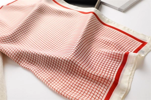 Detail of red and white checkered silk square scarf with premium smooth texture