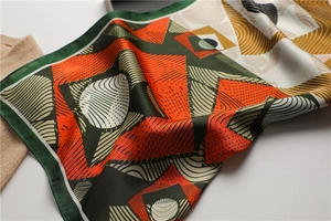 Detail of geometric pattern on silk scarf with smooth texture and colorful abstract curves
