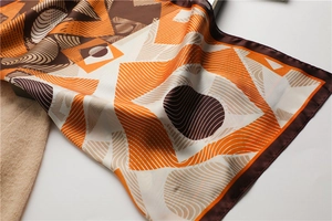 Detailed view of modern geometric silk scarf with bright orange and coffee tones
