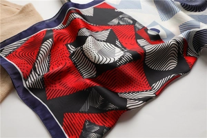 Detail of colorful geometric silk scarf with abstract wave patterns and contrast borders