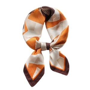 Elegant geometric silk scarf with orange and brown patterns in a stylish knotted display