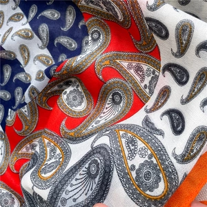 Detailed close-up of paisley pattern on lightweight cotton linen scarf with soft texture